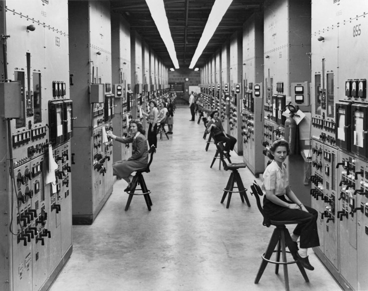 Rows of young women seated at calutron control panels at the Y-12 plant in Oak Ridge, 1944.
